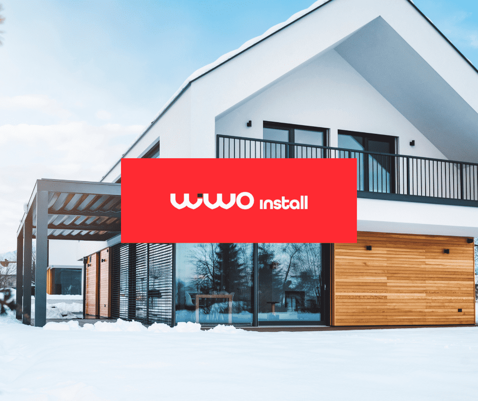 Nowoczesny dom jednorodzinny zimą z logo Wiwoinstall na elewacji